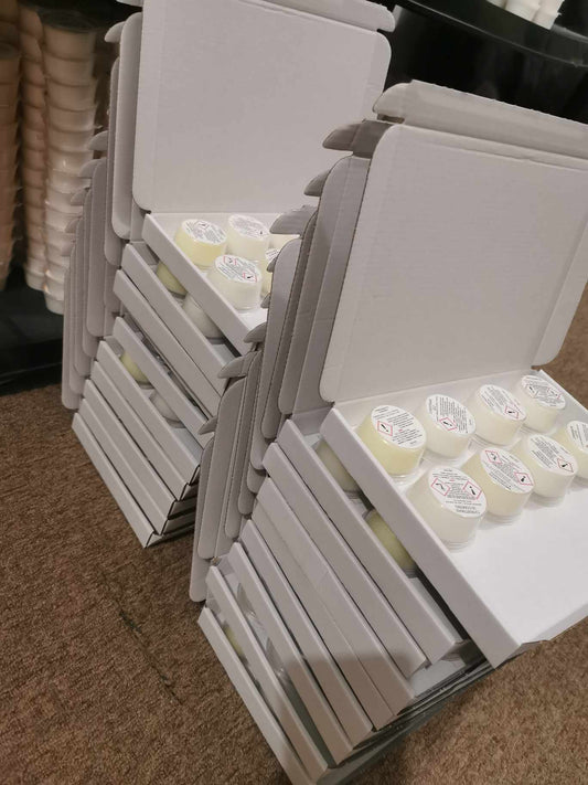 20 stacked boxes of tester wax melts displaying 8 wax melts per box with the CLP shown