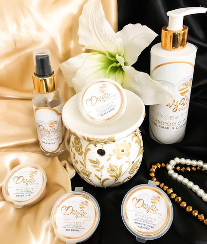 Daya's Essence products on cream surface, black background; blog on removing wax from carpets.