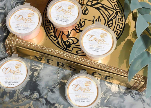 Four Daya's Essence wax melts on gold Versace box; paraffin myths debunked.