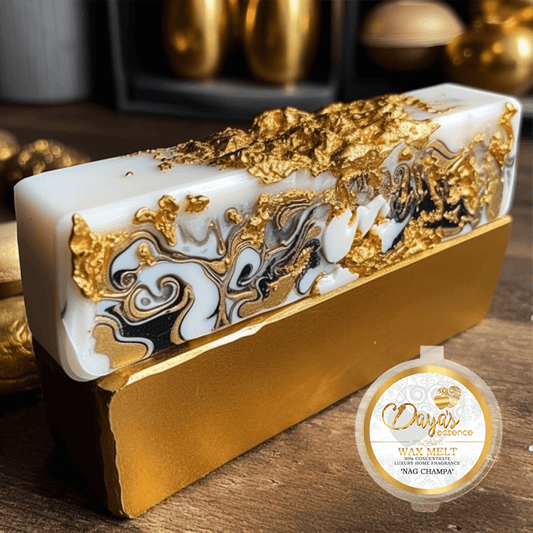 A 1oz tub boasts a branded sticker displaying the scent name "Nag Champa " Dayas Essence, 30% concentrated wax melt. The tub is positioned elegantly at the bottom right, behind the tub reveals an incense bar adorned with swirling patterns of black, gold, and white liquid paint, creating a luxurious vibe. This rests gracefully on a sleek gold bar, adding an element of refinement to the composition.